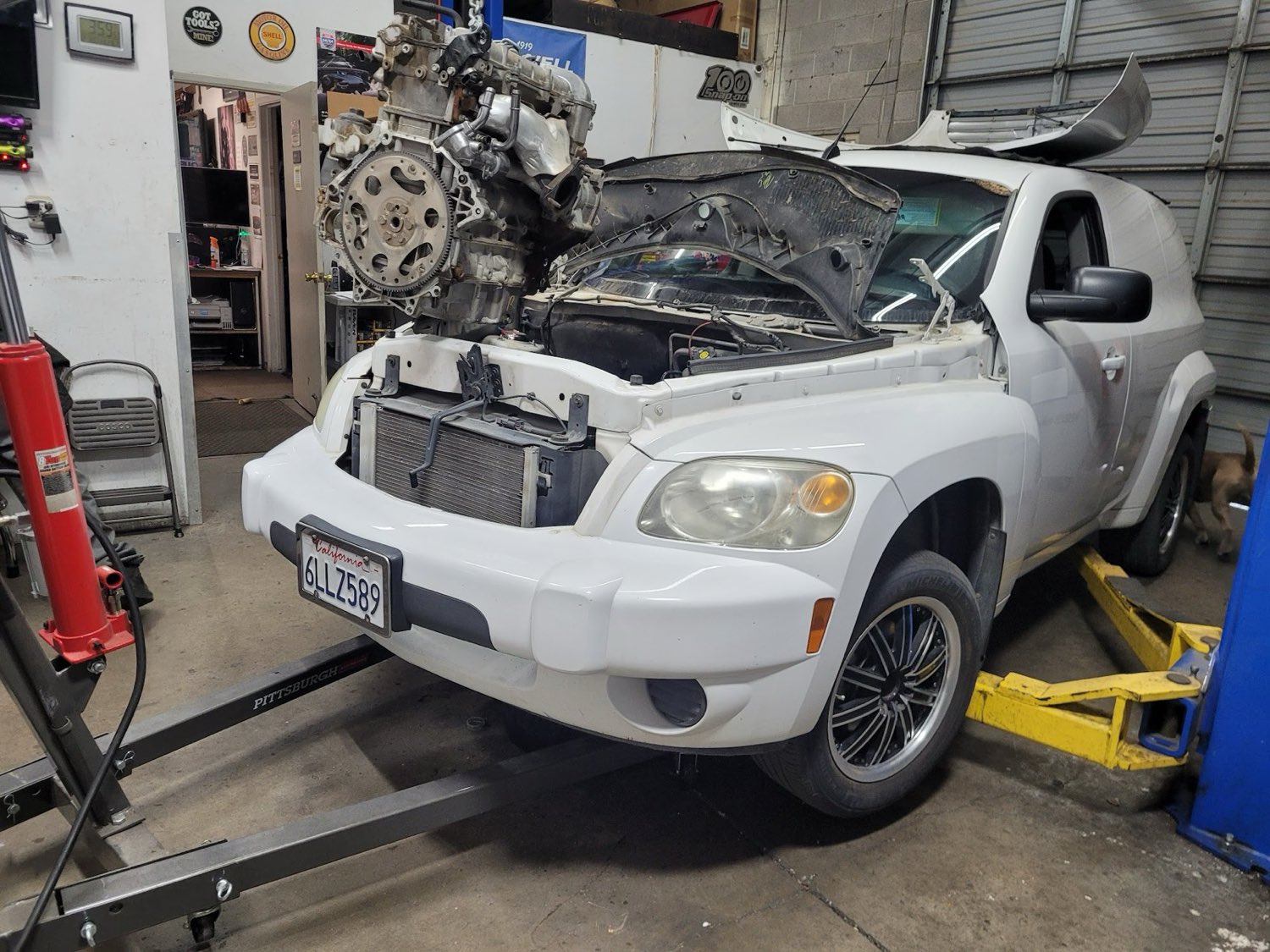Engine hoisted out of a vehicle for replacement in the Autoworks shop