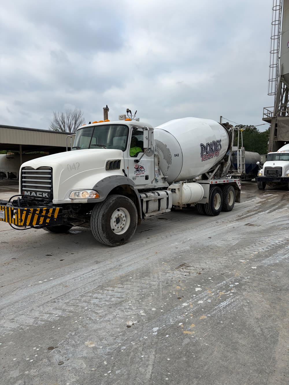 Pokie's Ready Mix Mack mixer truck rolling out of the batch plant