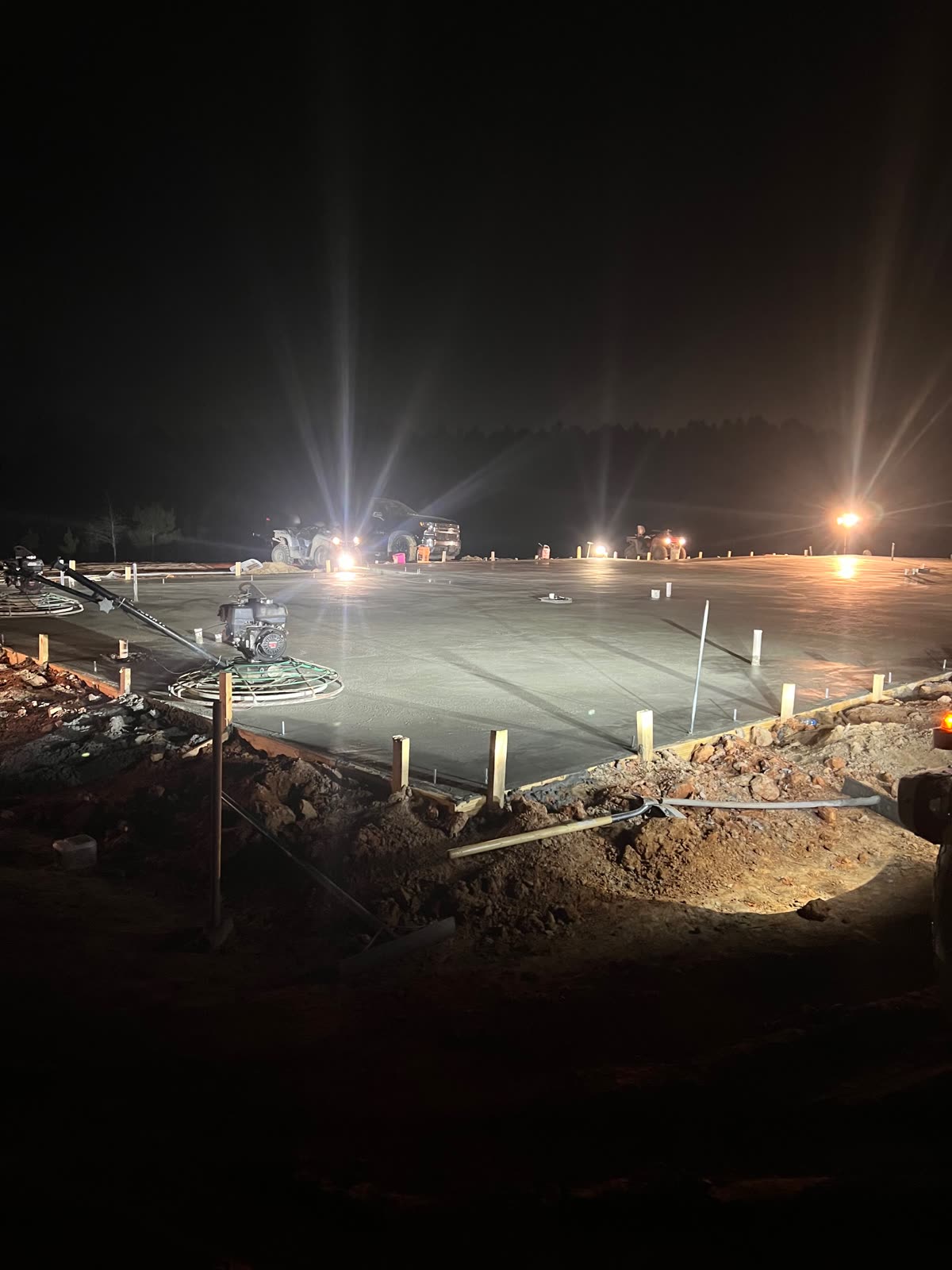Pokie's crew finishing a slab under lights on a night pour