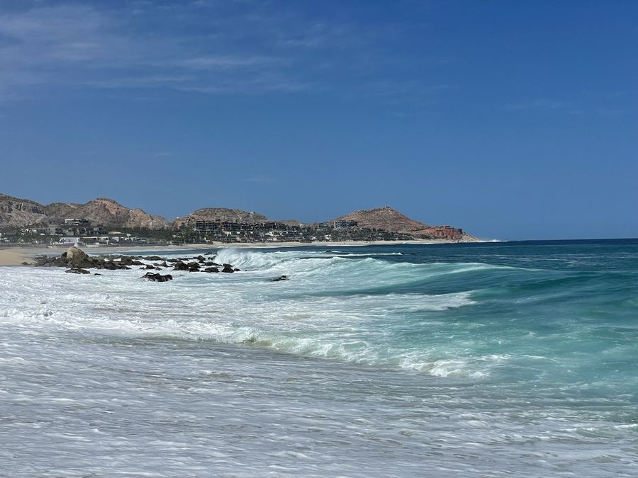 Turquoise water meeting a rugged desert coastline