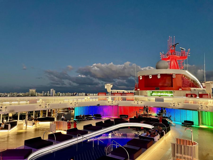 Cruise ship deck glowing at night over the sea