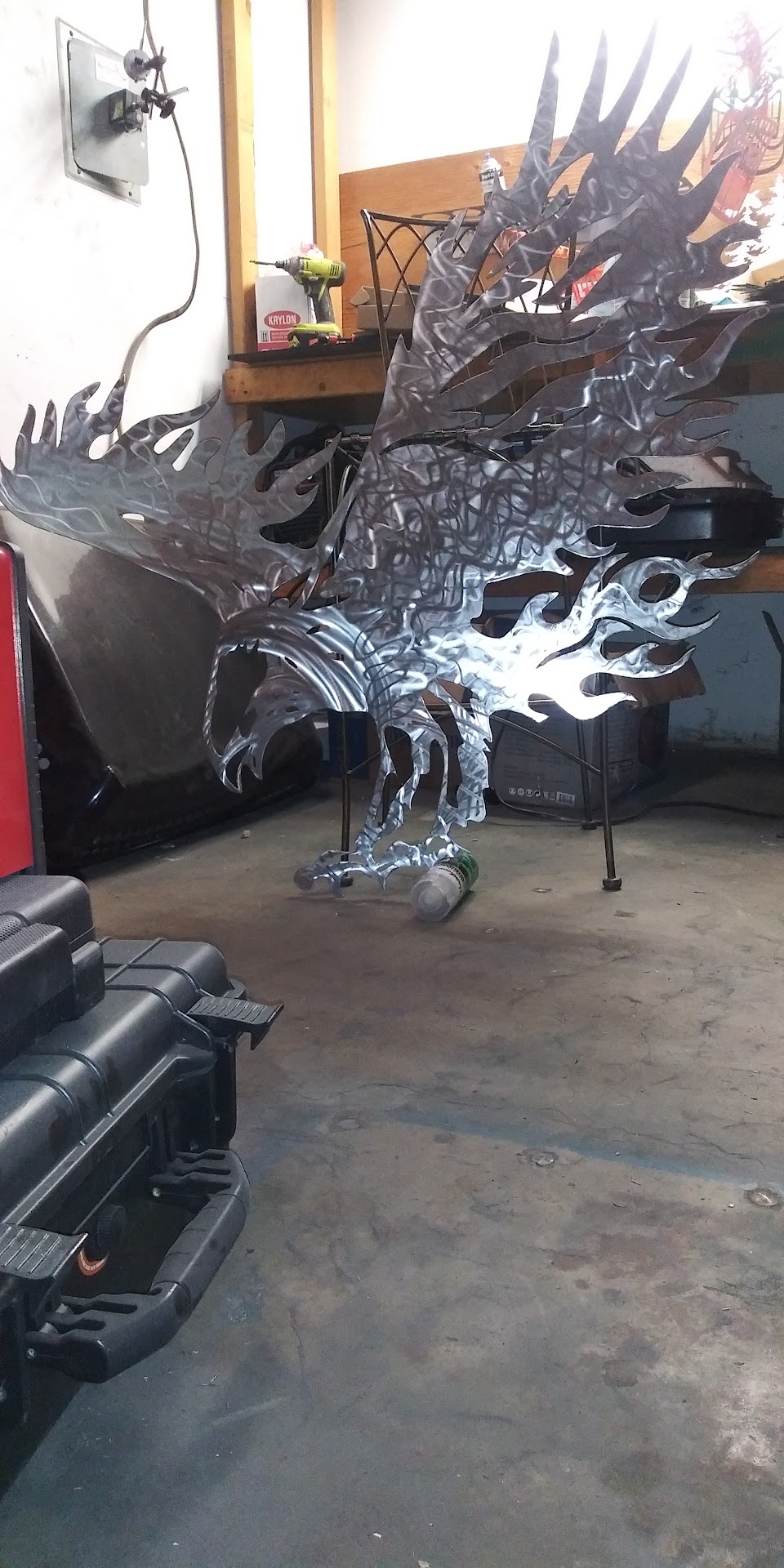 Plasma-cut brushed metal eagle sculpture in the Wicked Signs & Fabrication shop